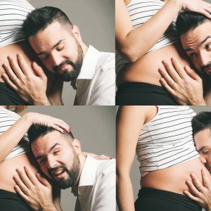 papà che ascolta e bacia il figlio nel pancione